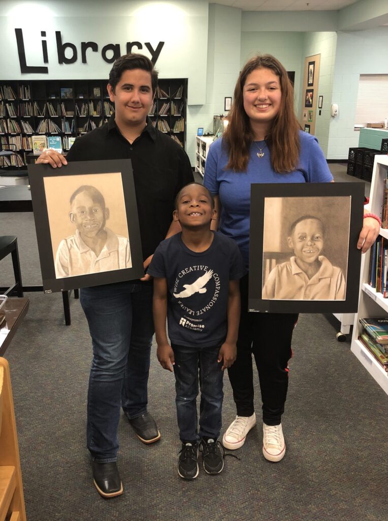 GCS Art Students were presenting Promise Academy Student with portraits.